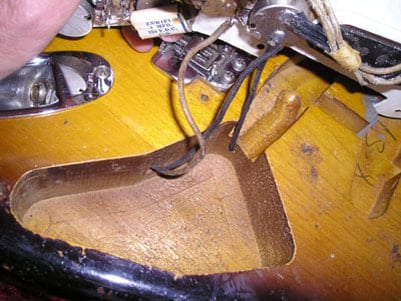 Bridge pickup and control cavities of a 1957 Stratocaster: note the worm route
