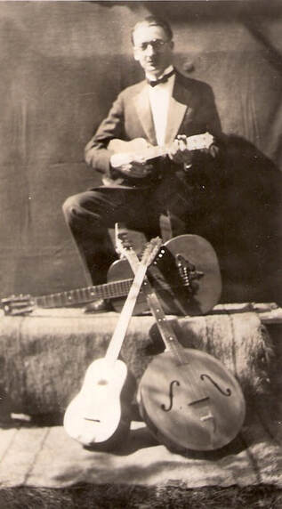 O. W. Appleton, circa 1925, posing with instruments made by his father, Jamie F. Appleton 