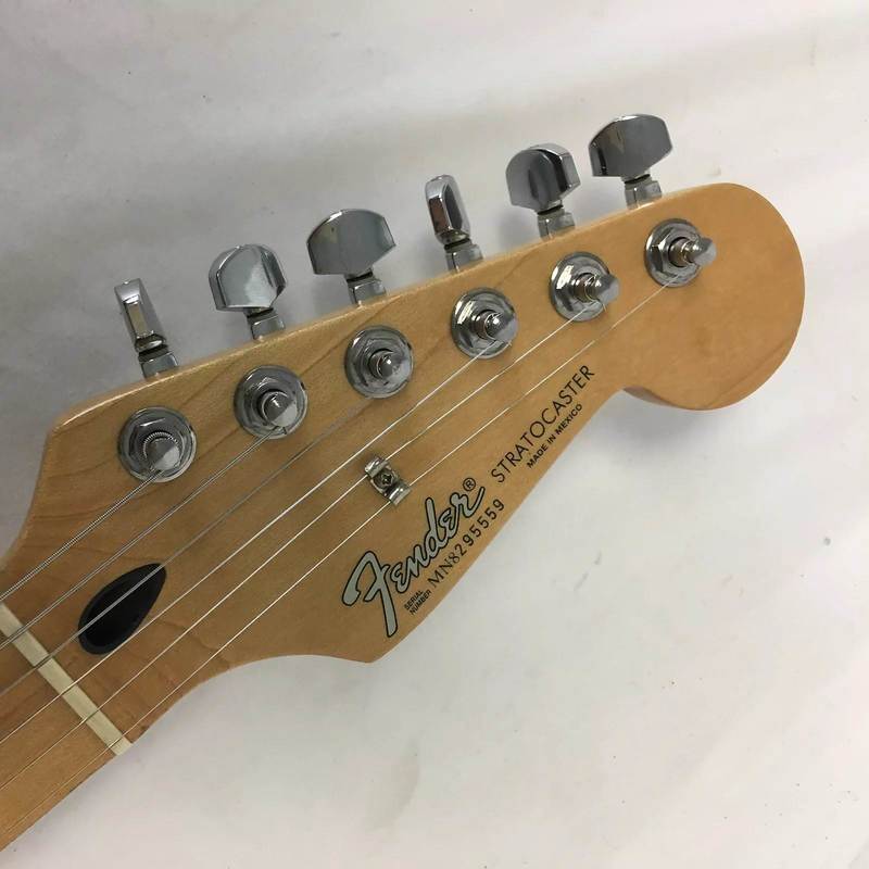 Headstock, Whitish Modern Logo and decals of the Standard Stratocaster, first Mexican Series. Note the black plastic truss rod access.