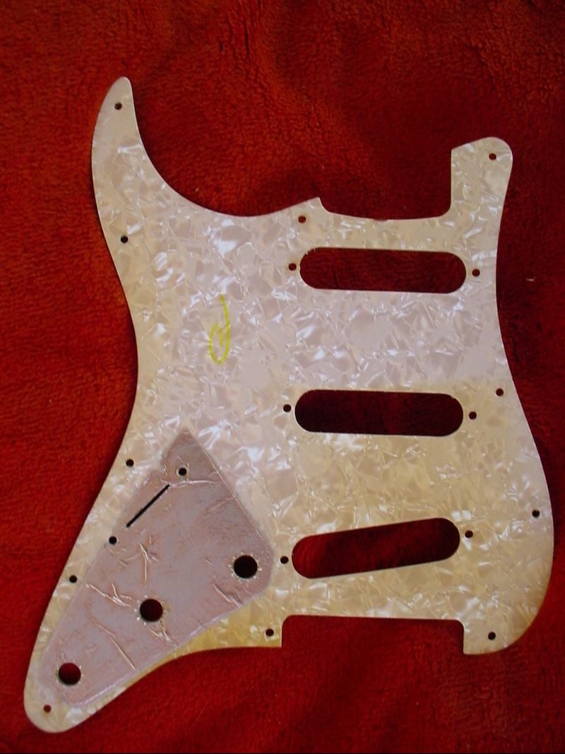 Pearloid bottom layer of a 1969 pickguard with the thin metal foil shielding that covered the control area