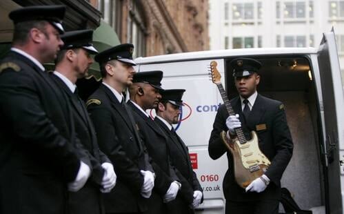 Rory's 1961 Fender Stratocaster arrive in a security van at Harrods, to be exposed at Born to be Rock (2007)