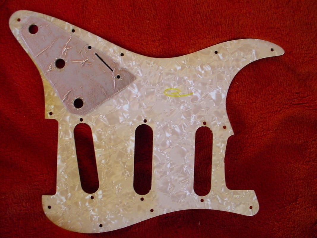 Pearloid bottom layer of a 1969 pickguard with the thin metal foil shielding that covered the control area