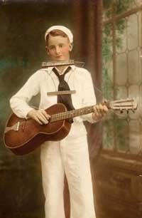 A young Les Paul with his Sears Troubador and harmonica